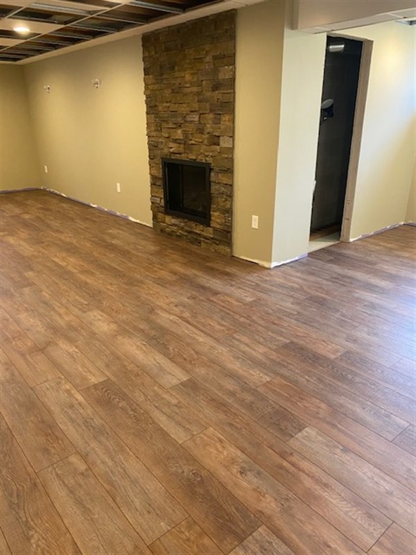 Laminate flooring — basement laminate install with stone fireplace